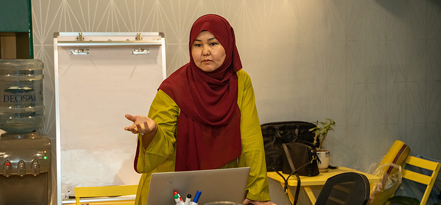 Sakina talking to a room during a programme session