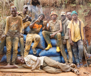 A group of gold miners smiling outside of a mine from our PeaceGold project. Reintegrating ex-combatants into communities in the DRC. 