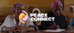 Two women working at a desk with a logo over the top reading 'Peace Connect'